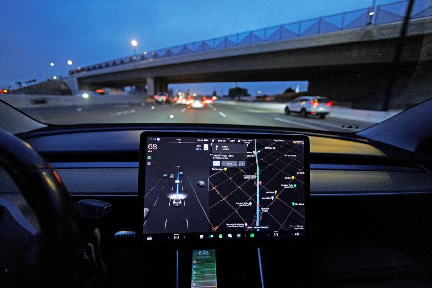 A Tesla Model 3 vehicle drives on autopilot along the 405 highway in Westminster, California, U.S., March 16, 2022. 