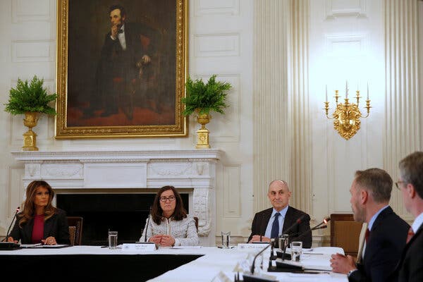 In 2018, Melania Trump, the first lady at the time, meets with tech leaders to discuss the effects of the internet on children. The group is sitting around a table in a room at the White House. 