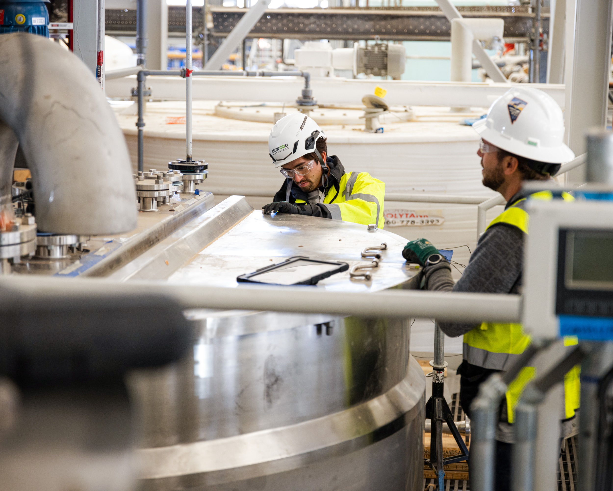 Two employees at work in the Redwood facility