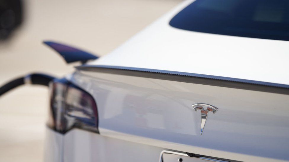 Tesla vehicle is plugged into a Tesla charging station in a parking lot on September 22, 2022 in Santa Monica, California.