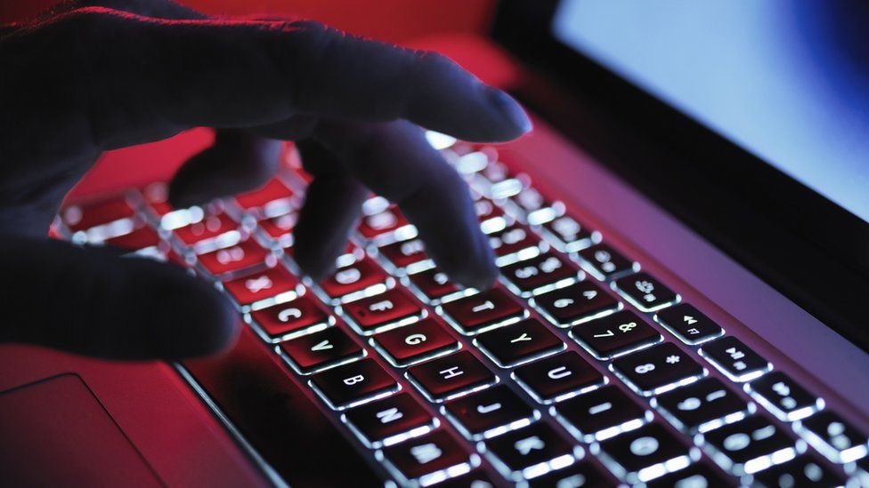 Person typing on a laptop (stock image)