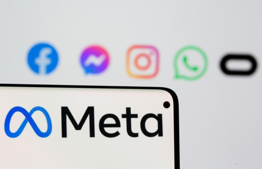 Facebook's new rebrand logo Meta is seen on smartpone in front of displayed logo of Facebook, Messenger, Intagram, Whatsapp and Oculus in this illustration picture taken October 28, 2021. REUTERS/Dado Ruvic/Illustration