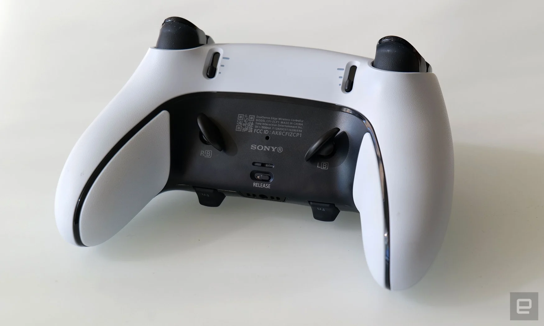 The back of the DualSense Edge features switches for adjusting the pull length of the triggers and magnetic slots for accommodating the controller's rear paddles. 