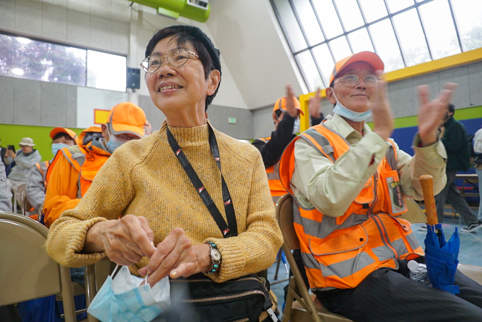 Josephine Josephine Hui, 75, at a local security event in Oakland sitting in a gymnasium as an audience member at a community meeting