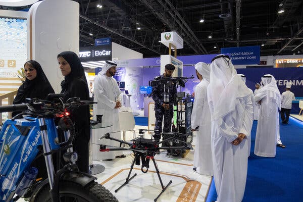 Attendees at the World Police Summit in Dubai look over new technologies.