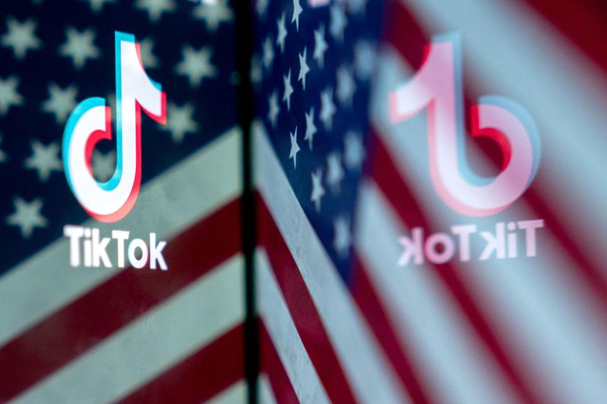 This photo illustration shows the TikTok logo reflected in an image of the US flag, in Washington, DC, on March 16, 2023. - China urged the United States to stop "unreasonably suppressing" TikTok on March 16, 2023, after Washington gave the popular video-sharing app an ultimatum to part ways with its Chinese owners or face a nationwide ban. (Photo by Stefani Reynolds / AFP) (Photo by STEFANI REYNOLDS/AFP via Getty Images)