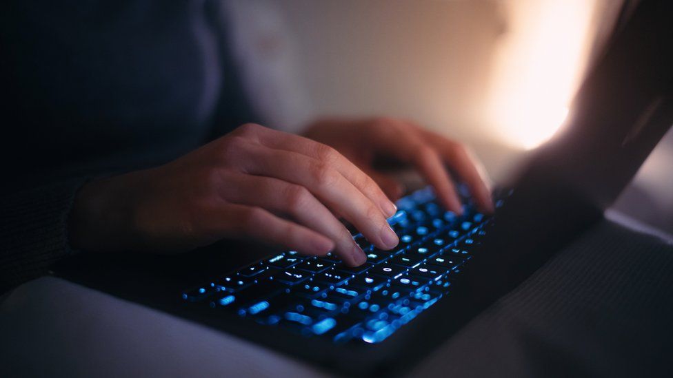 Woman's hands typing on keyboard