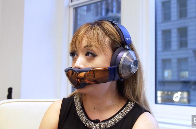 A woman wearing the Dyson Zone headphone and air filter combo unit.