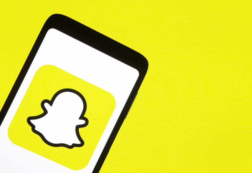 This illustration picture taken on 15 January 2021 shows the Snapchat logo displayed on a smartphone screen (Photo illustration by STR/NurPhoto via Getty Images)