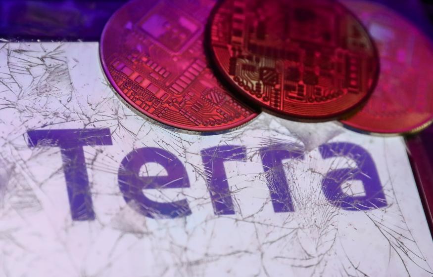 Terra logo displayed on a phone screen is seen through a broken glass with representation of cryptocurrency in this illustration photo taken in Krakow, Poland on May 12, 2022. (Photo Illustration by Jakub Porzycki/NurPhoto via Getty Images)