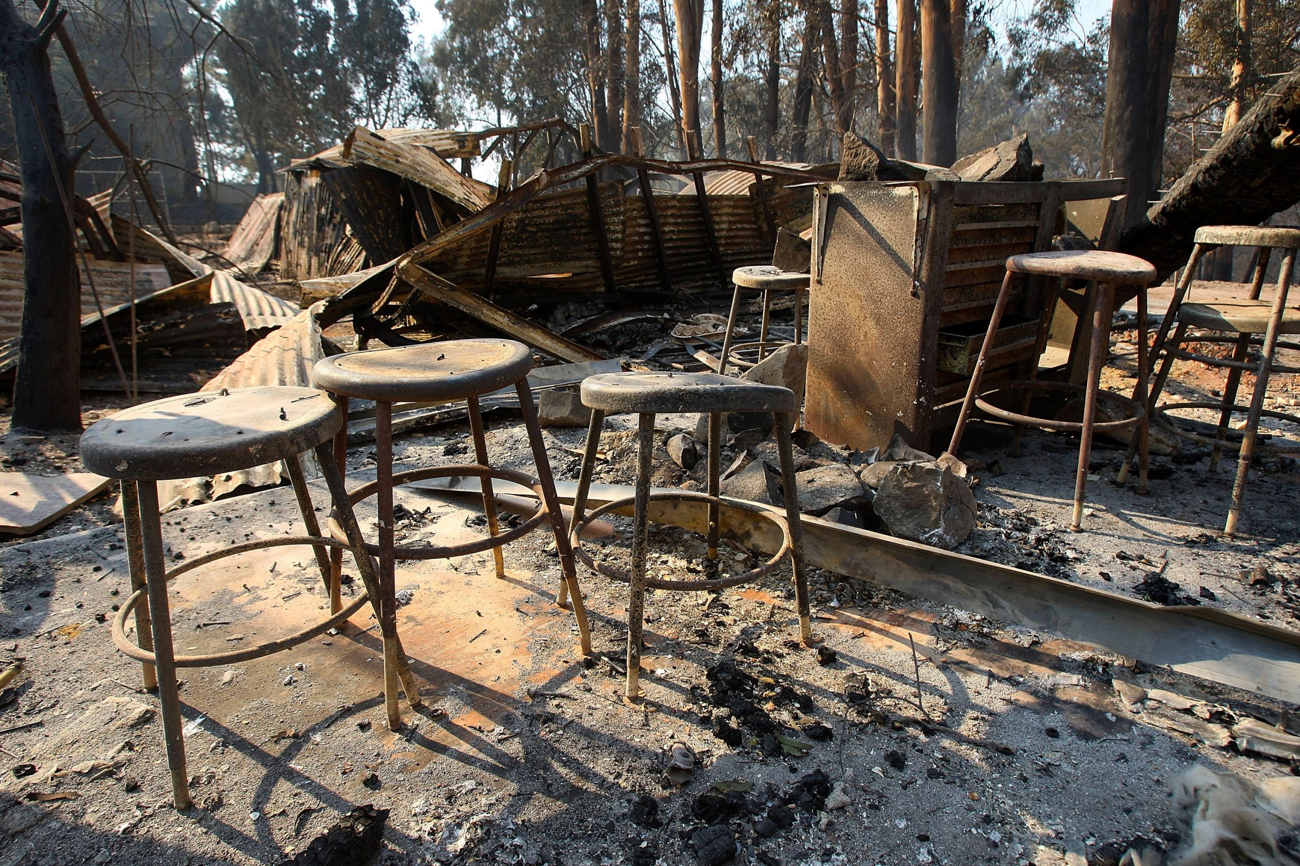 Metal stools stand in the ruins left at Westmont College by the Tea Fire in Montecito, California