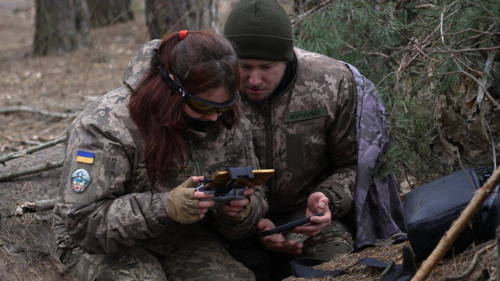 Drone pilots in a dug out