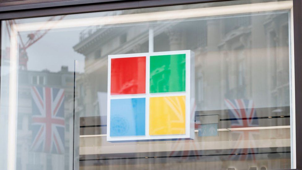 Union Jack flags reflected in the window of the Microsoft Experience Centre in London, England