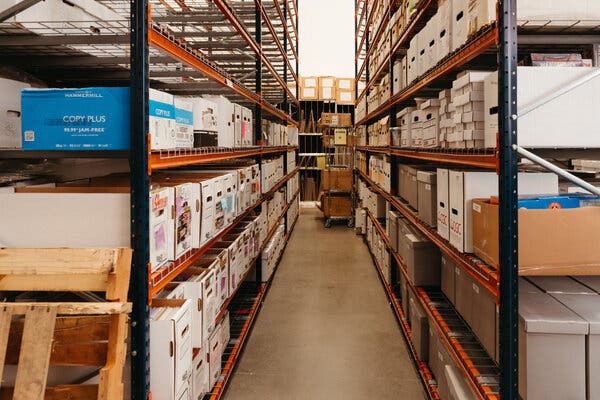 Rows of long, free-standing shelves holding dozens of cardboard boxes of varying sizes and colors.