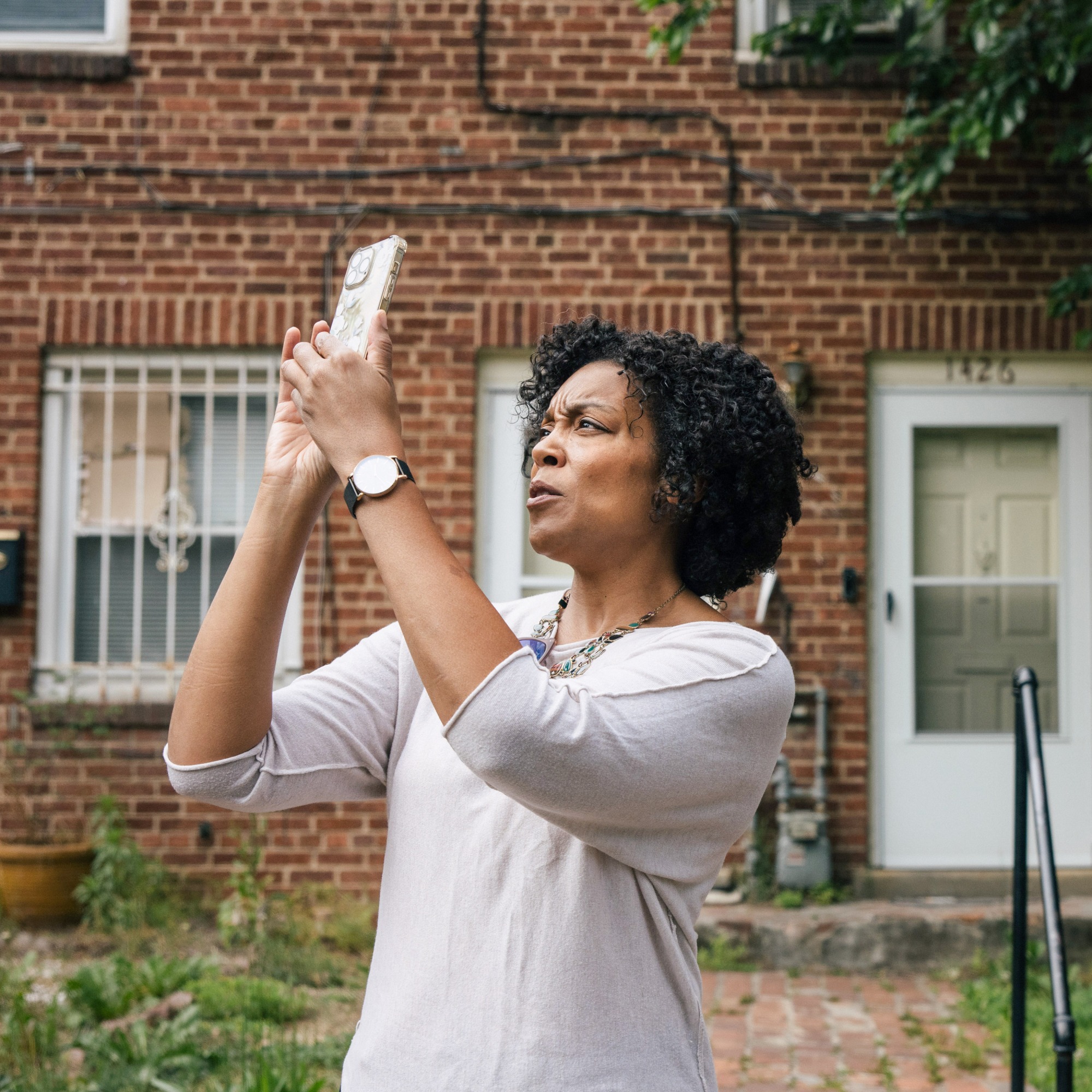 Monica Sanders holds up her phone to take a photo