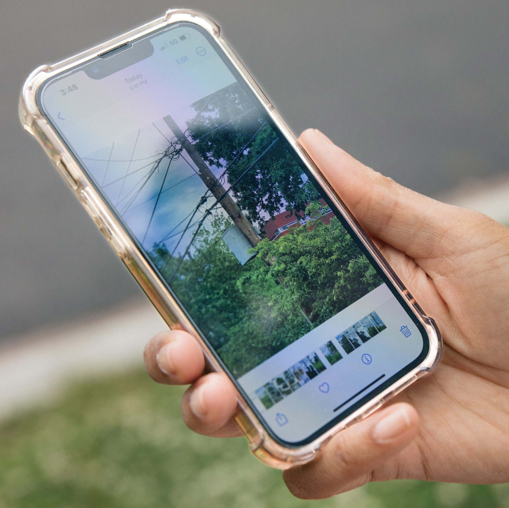 a close-up of Sanders' cell phone screen showing a photo she captured of a utility pole with wires