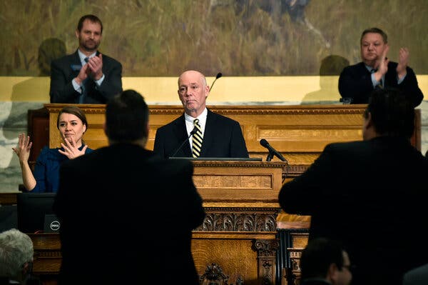 Greg Gianforte delivering a State of the State address from behind a wooden dais. 