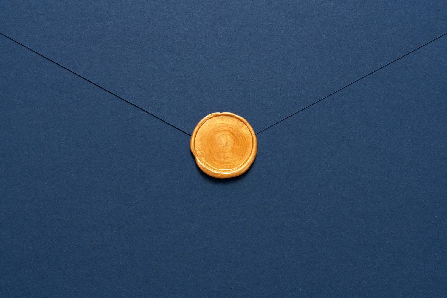 Blue Envelope Sealed With Gold Colored Wax Stamp Close-up Directly Above View.