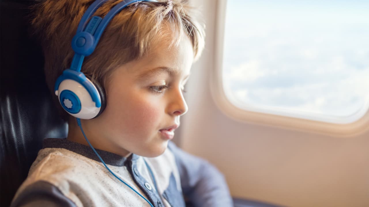 Boy on Airplane wearing headphones