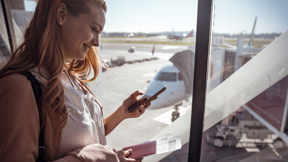 Woman using phone in an airport