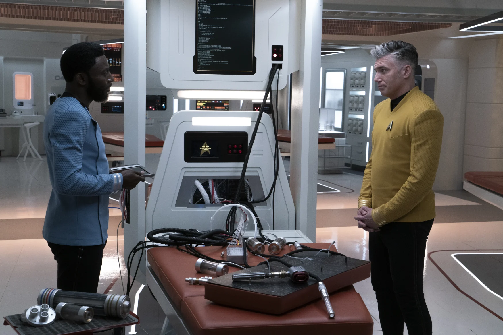 L-R Babs Olusanmokun as Dr. M'Benga and Anson Mount as Capt. Pike in Star Trek: Strange New Worlds streaming on Paramount+, 2023. Photo Credit: Michael Gibson/Paramount+ 