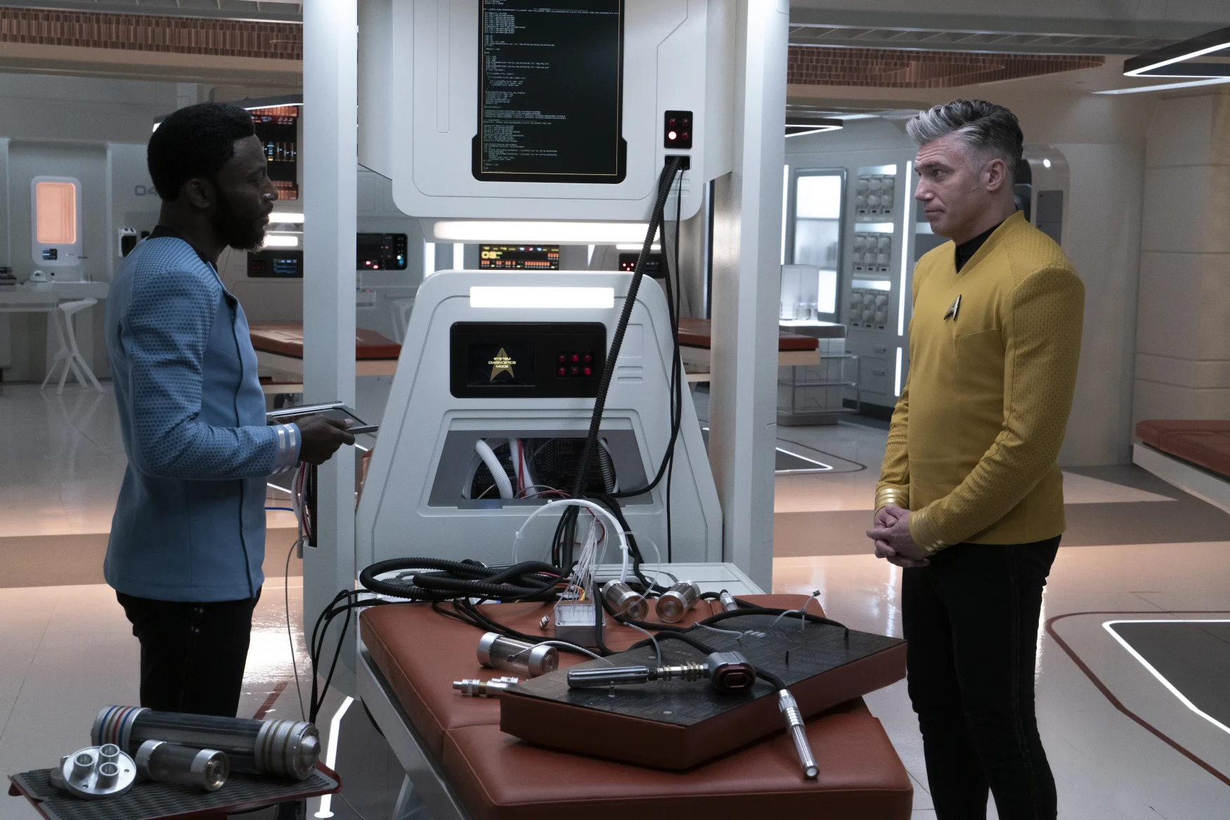 L-R Babs Olusanmokun as Dr. M'Benga and Anson Mount as Capt. Pike in Star Trek: Strange New Worlds streaming on Paramount+, 2023. Photo Credit: Michael Gibson/Paramount+