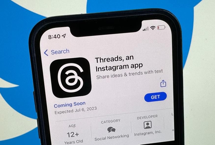 04 July 2023, Berlin: The announcement of the social media app Threads is displayed in Apple's US App Store. The Twitter logo can be seen in the background. The eagerly awaited Twitter competitor from Facebook Group Meta is scheduled to launch on July 6, 2023.      (to dpa "Facebook Group to make Twitter competitor available soon") Photo: Christoph Dernbach/dpa (Photo by Christoph Dernbach/picture alliance via Getty Images)