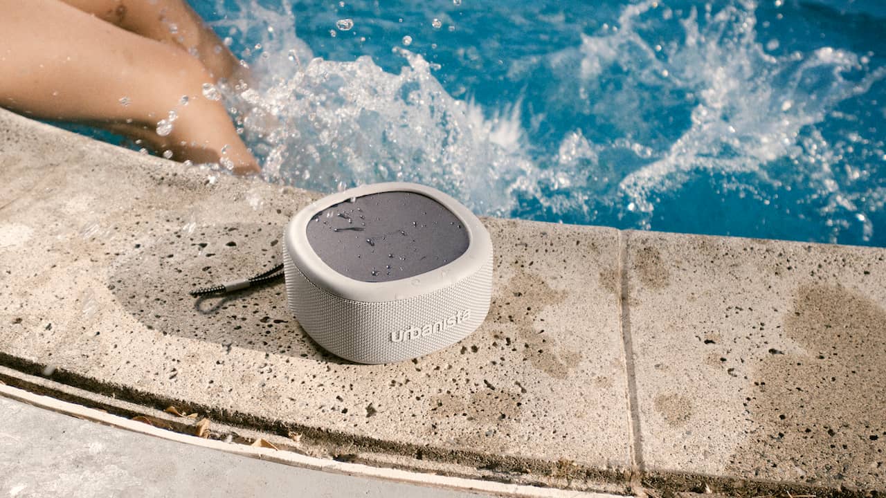 Urbanista Malibu Portable Bluetooth Speaker by Pool in Desert Gray