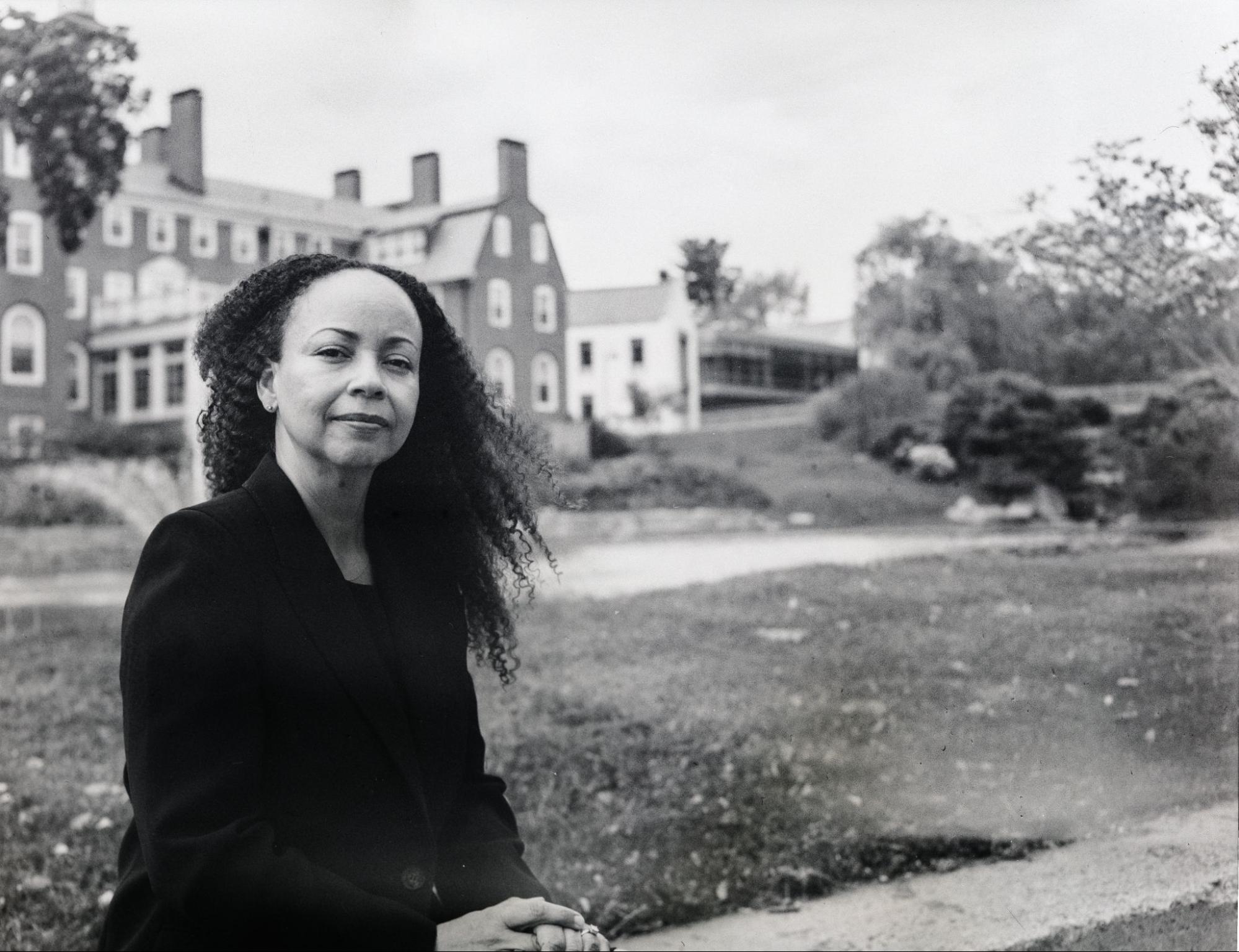 Window Snyder poses in front of a building at her old high school, Choate Rosemary Hall.