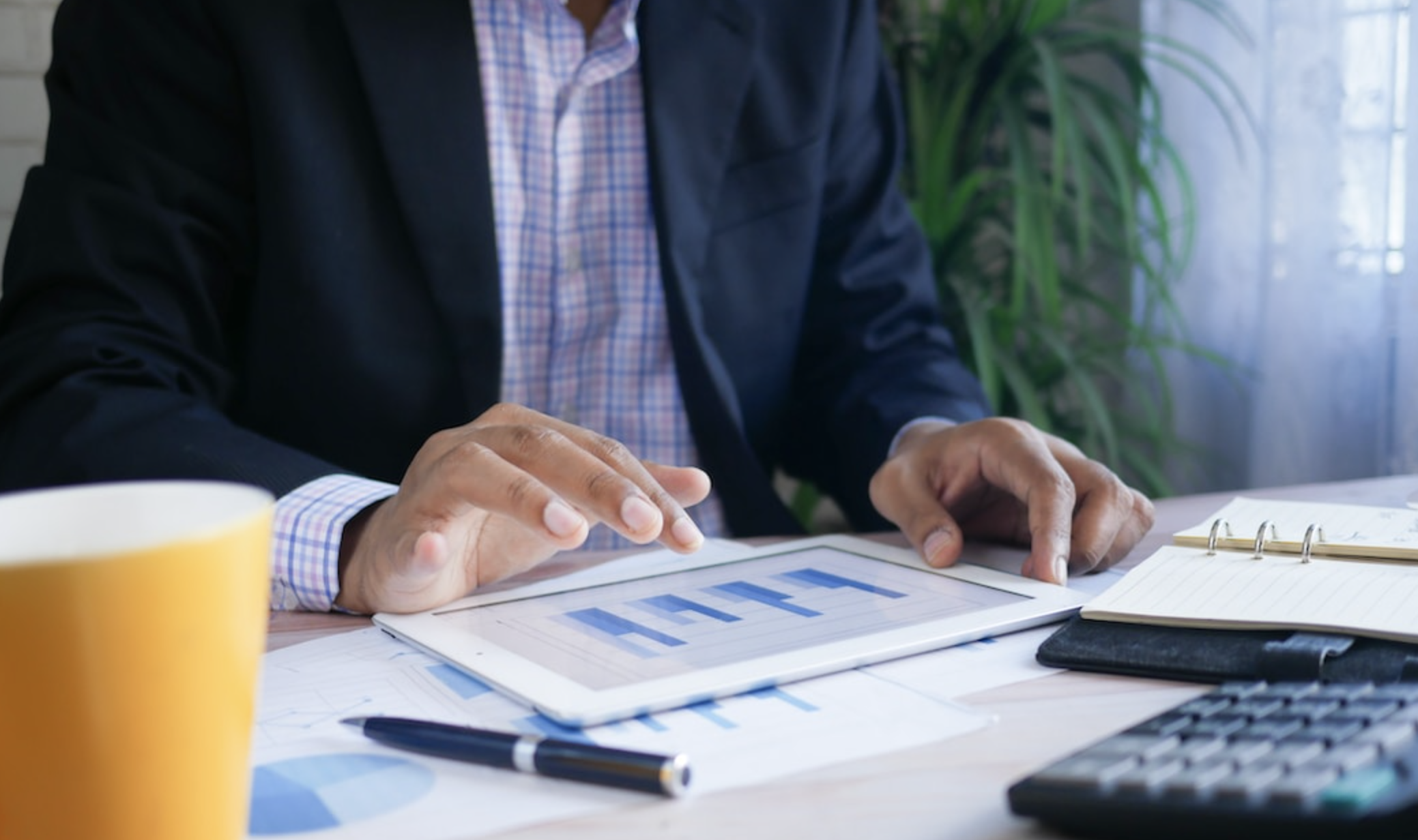 Businessman using smart device tablet to look at data and create treemap chart