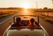 two people in card looking at sunset; summer season