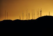 A silhouette image of telecommunications towers