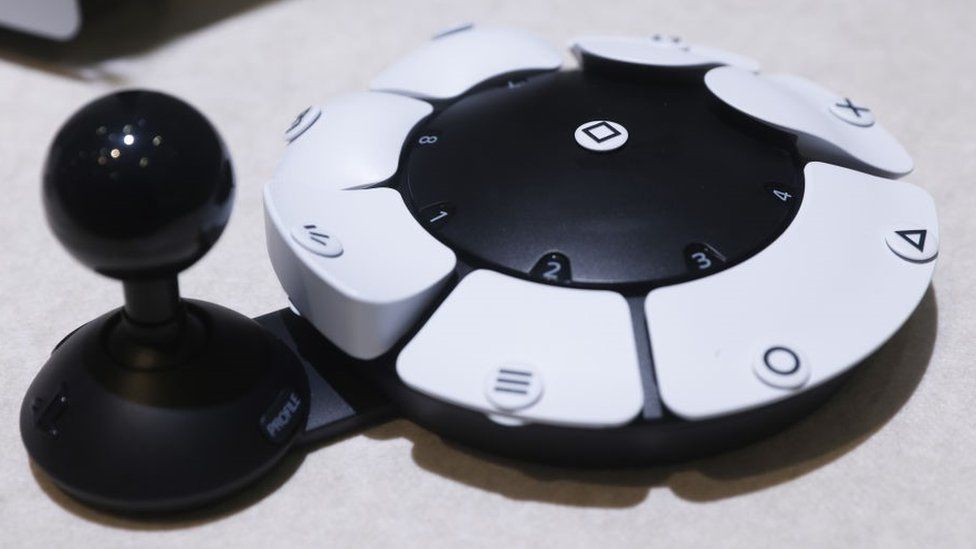 The Access Controller looks like a circle with buttons on it and a joystick