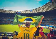 Man holding Brazil flag at football match