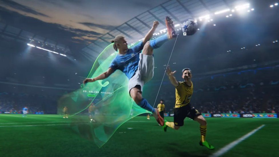 A computer-generated version of Erling Haaland, in Manchester City's sky blue home strip, leaps for the ball in the middle of a match in EA Sports FC 24. He's in mid-air, in a karate kick-style pose and has one leg stretching out his orange football boot to make contact with the ball. A bright green vapour trail emanates behind him, showing the path he's followed. Another player is nearby and looks desperate as he tries to intercept Haaland.