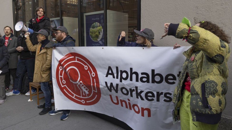 A group of people protesting outside a building