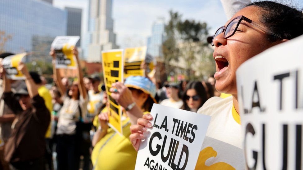 Los Angeles Times Guild members rally outside City Hall against ‘significant’ imminent layoffs at the Los Angeles Times newspaper during a one-day walkout