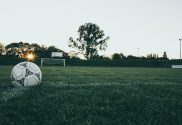 Soccer ball on grass in dusk